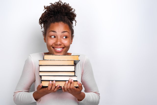 640-portrait-of-happy-nerd-young-girl-holding-books-over-white-background-back-to-school
